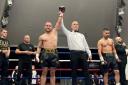 Ryan Walsh's arm is raised in victory by referee  Sean McAvoy