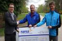 NANSA Trustee Tom Garrod receives a cheque from Swaffham Golf Club Captain Keith Edmond and Head PGA Professional Alan Wright. Picture: NANSA