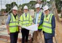 Leader of Breckland Council, Sam Chapman-Allen (centre) and Gordon Bambridge (right) from Breckland Council join Michael Newey, chief executive of Broadland Housing on the building site in Elm Road