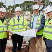 Leader of Breckland Council, Sam Chapman-Allen (centre) and Gordon Bambridge (right) from Breckland Council join Michael Newey, chief executive of Broadland Housing on the building site in Elm Road