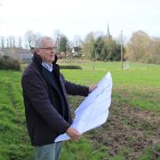 David Winch, director of The Land Group, inspecting the proposed development in Banham