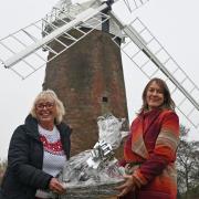 Breckland councillor Alison Webb hands Christmas presents over to Leigh Doran from the Daisy Programme at Dereham Windmill