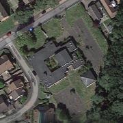 The five homes would go up in a single building to the north east of the community centre in the middle of the image.