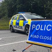 Suffolk Police have closed Eriswell Road near Mildenhall after a two-vehicle collision left a car on its roof
